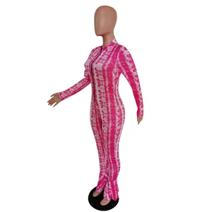 Detail view of pink tie-dye slim fit jumpsuit with flared mermaid hem and front zipper.