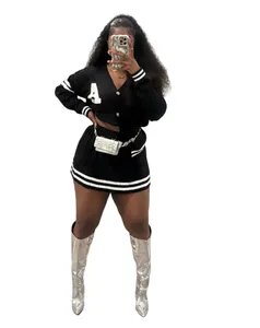 Stylish black knit cardigan and mini skirt set with varsity stripes and silver boots