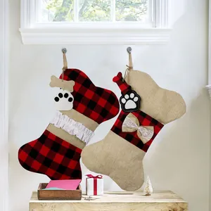 Detail view of bone-shaped Christmas stockings with buffalo plaid and burlap texture