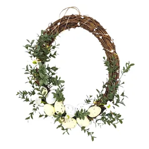 Spring Easter wreath with artificial speckled eggs and greenery for door decoration