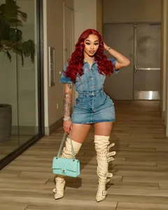 Chic short sleeve denim mini dress with buttons shown on fashion model in hallway