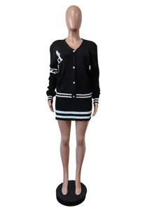 Close-up view of a black two-piece knit set featuring a striped cardigan and mini skirt