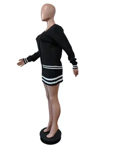 Detailed side view of black knit cardigan and mini skirt set with white stripe details.