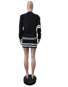 Back view of women's black two-piece knit set with white stripes, sweater and skirt.