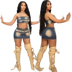 Detail view of a two-piece denim tube top and mini skirt set with large decorative buckles.