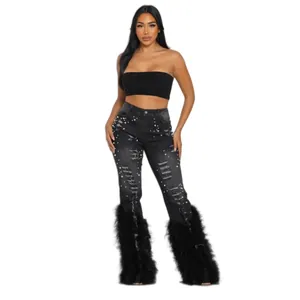 Trendy distressed black high-stretch flare jeans with pearl accents and feather hem