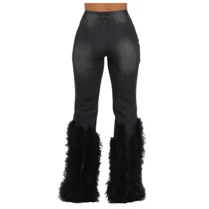 Womens high waisted distressed grey denim jeans featuring bold black feather trim