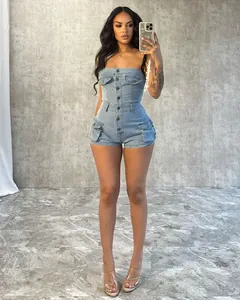 Model wearing a strapless light blue denim romper with buttons and cargo pockets.