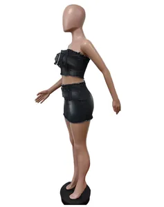 Detailed side view of a stylish black washed denim crop top and mini skirt set.