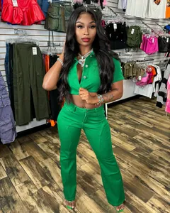 Model wearing a vibrant green two-piece denim set with crop top and flared pants.