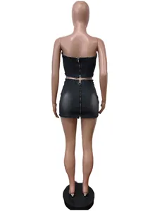 Back view of two-piece dark denim set with strapless top and mini skirt with zippers