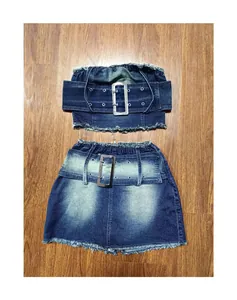 Close-up detail of two-piece denim set featuring large silver buckles and frayed edges