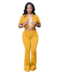 Two-piece yellow denim set featuring short sleeve crop jacket and high waist flare jeans