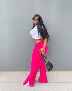 Plus size vibrant pink wide-leg casual pants with stylish side slits shown in lifestyle pose
