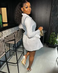 Side view of stylish white flared sleeve shirt dress with blue denim corset vest