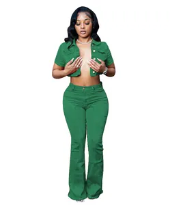 Detail view of a stylish green short-sleeved cropped denim jacket and flare pants.