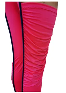 Macro detail shot of the vibrant pink ruched fabric and navy piping on a slim jumpsuit