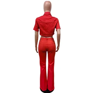 Back view of a red denim two-piece set featuring short-sleeve crop top and flare pants