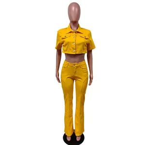 Full front view of a vibrant yellow denim set featuring short sleeve shirt and flared pants