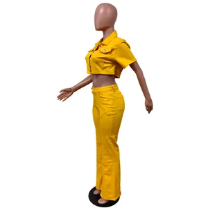 Side profile detail of a vibrant yellow denim short sleeve crop top and flared pants set.