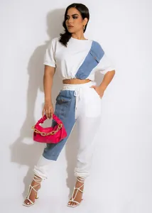 Close-up detail of two-piece white and blue denim patchwork tracksuit set for women