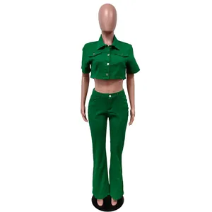 Detail view of a vibrant green denim two-piece set with cropped jacket and flare pants.