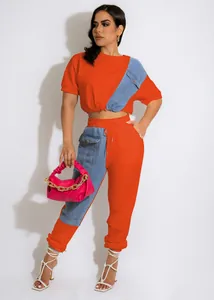Detail shot of a two-piece leisure set in bright orange and denim blue.