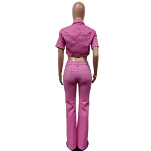 Back view of a pink denim two-piece set with cropped jacket and flared pants.