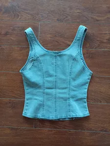Detailed back view of a light blue denim vest with vertical stitching