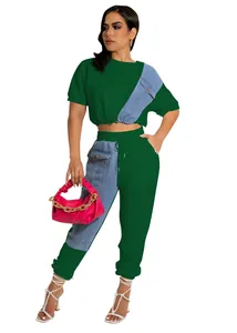 Stylish two-piece set featuring a green top and denim patchwork joggers with pink bag