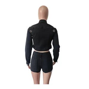 Back view of black denim set featuring cropped long sleeve jacket and slim shorts
