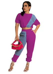Detail of magenta two-piece casual set featuring denim patchwork and jogger pants