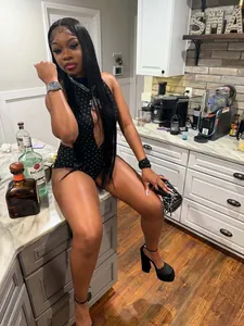 Trendy black polka dot studded halter neck backless stretch bodysuit romper worn by a model
