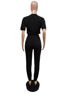 Back view of a black two-piece casual set featuring a short-sleeve top and slim pants.