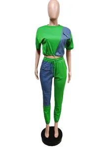 Full view of green and denim patchwork casual sports set on a professional mannequin