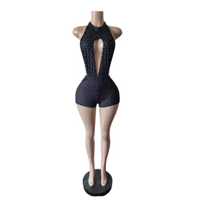 Detail view showing the halter neck and front keyhole cutout of the polka dot romper