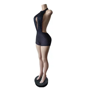 Close-up side view of a black halter neck polka dot backless bodycon romper for women