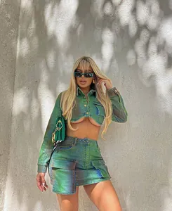 Lifestyle shot of an iridescent green spray-paint denim skirt set on a model outdoors