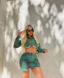 Stylish two-piece denim skirt set with a vibrant green spray-paint gradient effect.