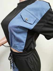 Detailed close-up of a color-block denim casual set featuring a blue pocket
