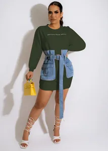 Detailed view of dark green sweatshirt dress with denim corset belt and embroidery.