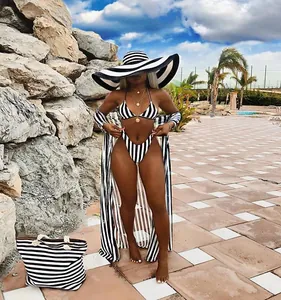 Detail of black and white striped 3-piece bikini set with long beach cover-up.