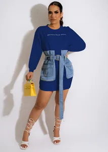 Close-up detail of blue mini dress with denim patchwork pockets and embroidered text