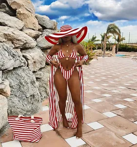 Red and white striped three-piece bikini set with matching cover-up and sun hat.