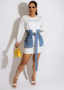 Detailed shot of white sweatshirt dress with denim waist corset and adjustable belt detail