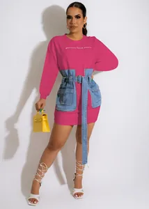 Macro detail of pink sweatshirt dress featuring a denim corset belt and Italian embroidery.