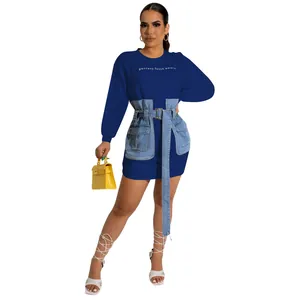 Detailed view of royal blue long sleeve dress featuring denim patchwork and waist belt