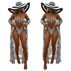 Stylish three-piece striped bikini set including a long beach cover-up and sun hat