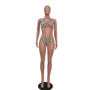 Detailed macro view of black and white vertical striped bikini set on a female mannequin