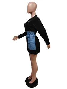 Detailed side view of a black long sleeve mini dress with denim patchwork and belt